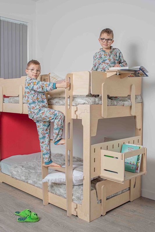 Low loft bed with desk and chairs underneath, showing a space-saving study and sleep setup for a shared kids’ room