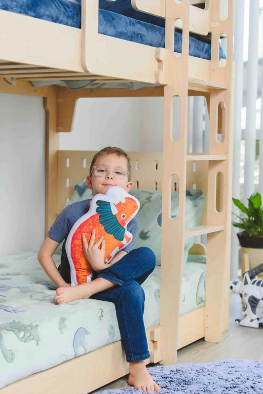 Children’s loft bed with a desk and chairs underneath, creating a space-saving sleep and study area for kids